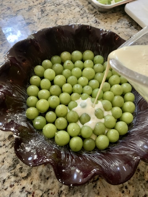 pouring batter over grapes