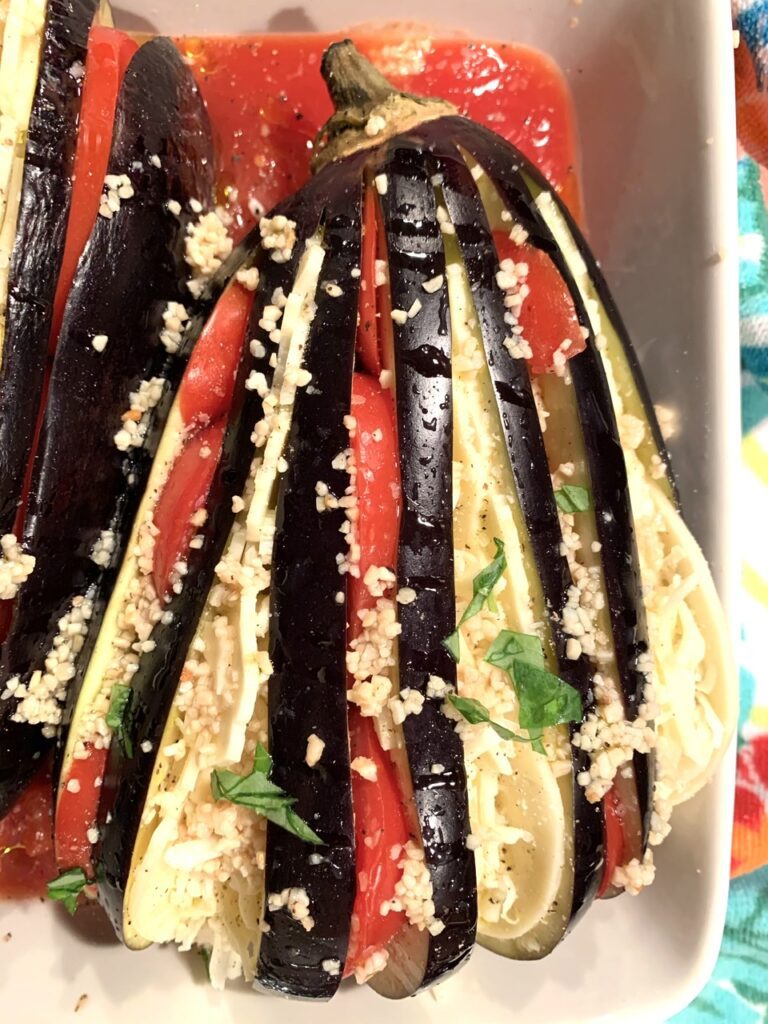 FInserting ingredients betweens slices of eggplant
