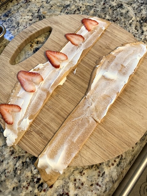 Spreading cream and Arranging strawberries on crepe