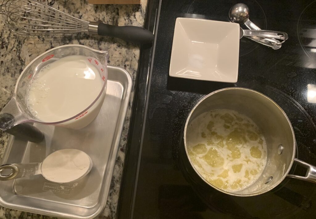 Melting butter for Fluffy Three-Cheese Soufflé