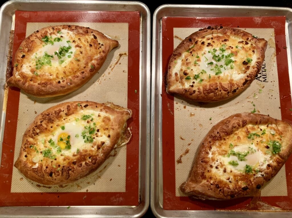 Topped with chopped green onions Adjaruli Khachapuri (Georgian Cheese Bread)