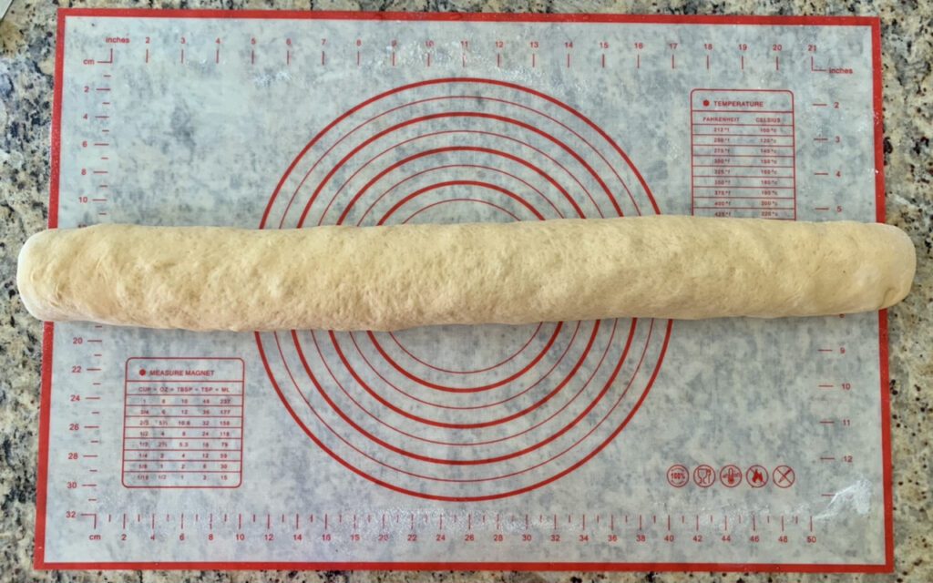 Rolling up the dough for Spanish Inspired Ham & Cheese Spiral Muffin Bread