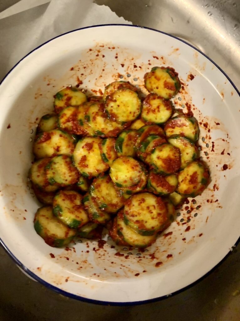 Placed seasoned cucumber slices into colander to drain