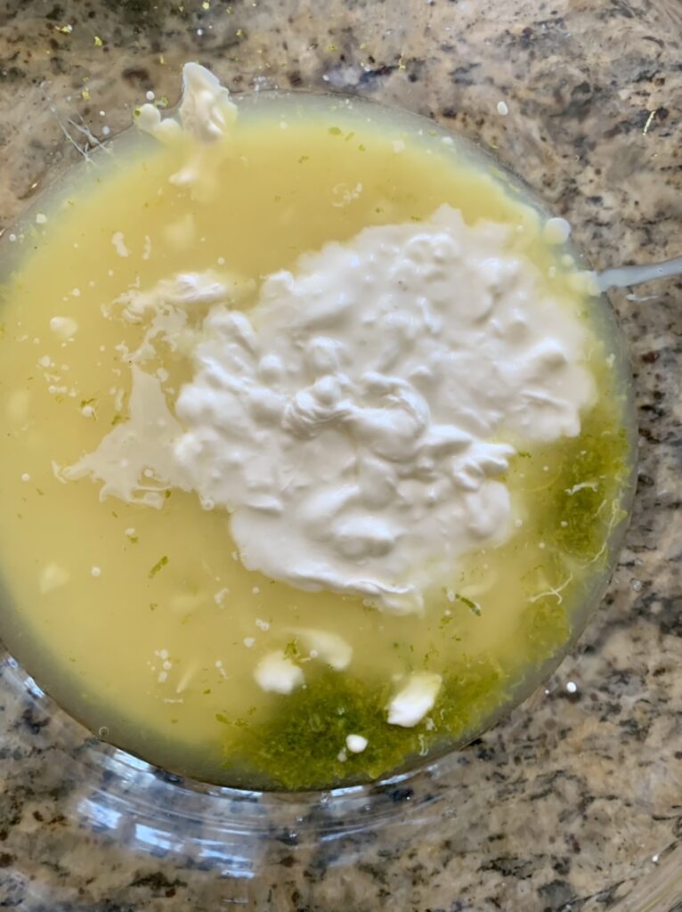 Adding condensed milk and yogurt to lime juice & zest